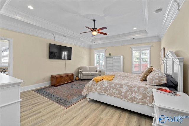 bedroom featuring ornamental molding, a raised ceiling, baseboards, and wood finished floors