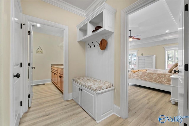 mudroom with crown molding, light wood-style flooring, baseboards, and ceiling fan