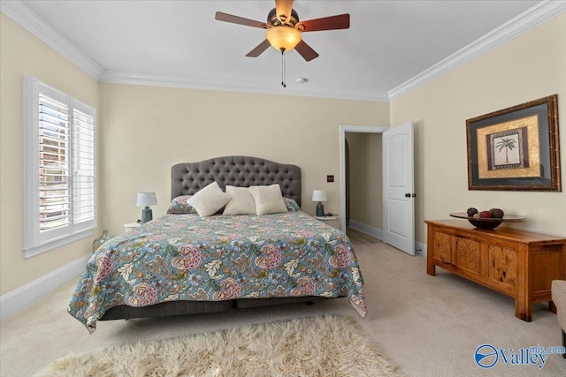 carpeted bedroom with a ceiling fan, baseboards, and crown molding