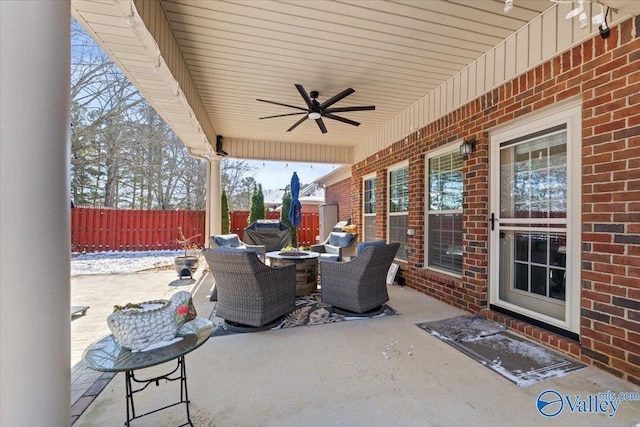 view of patio / terrace with fence and a ceiling fan