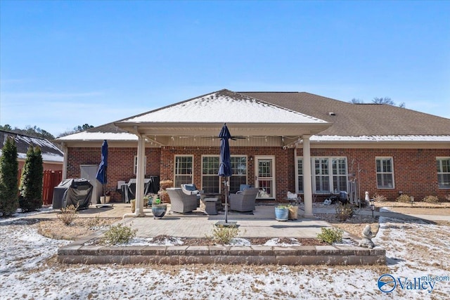 rear view of house with a patio area, an outdoor hangout area, and brick siding