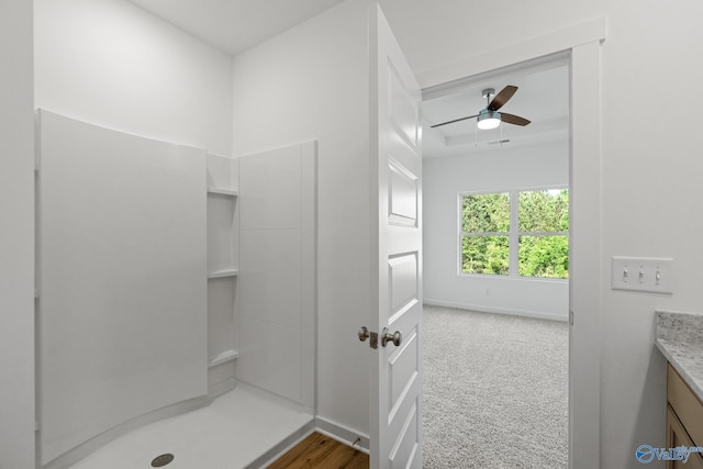 full bath with a shower, ceiling fan, vanity, and baseboards