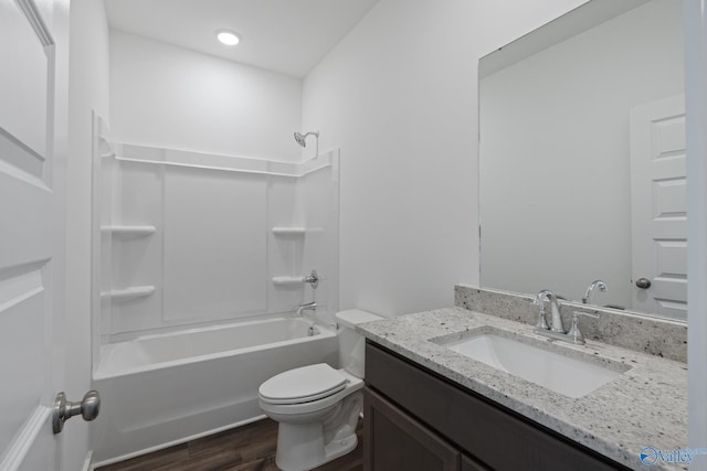 full bathroom featuring toilet, bathing tub / shower combination, wood finished floors, and vanity