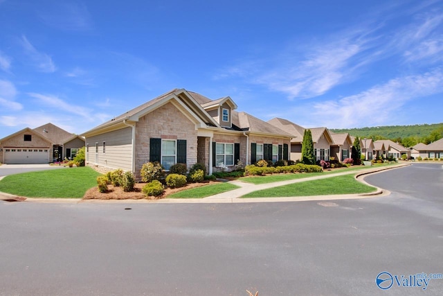 view of front of property with a garage and a front lawn