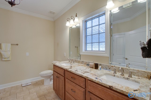 bathroom with toilet, vanity, tile patterned floors, and crown molding