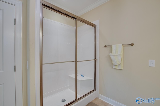 bathroom with ornamental molding, an enclosed shower, and tile patterned floors