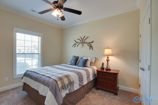 carpeted bedroom with ceiling fan and crown molding