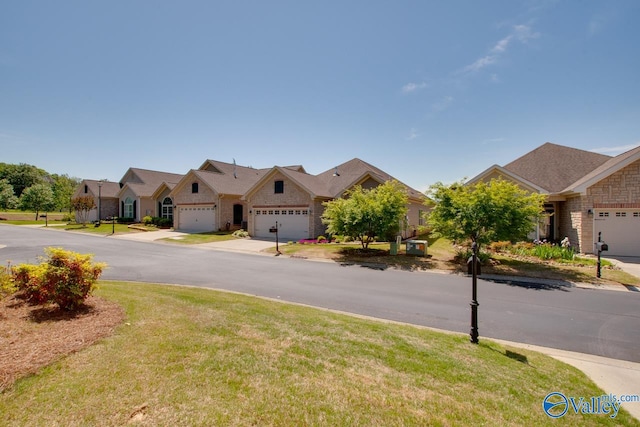 view of front of house featuring a garage and a front lawn