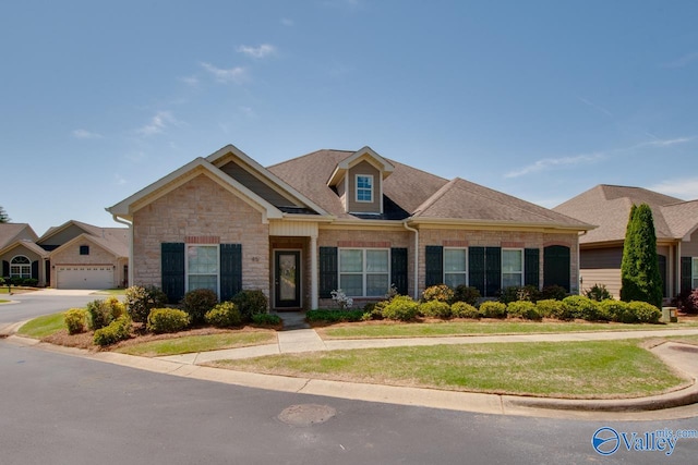 view of front of home with a garage and a front lawn