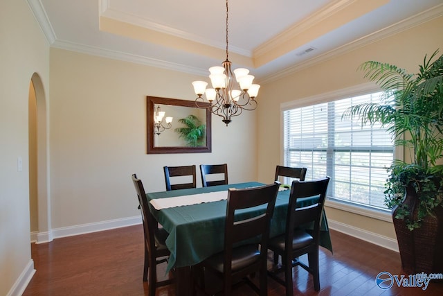 dining room with crown molding, a healthy amount of sunlight, and dark hardwood / wood-style floors