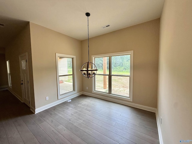 1112 Mountainview Rd NE, Hartselle, AL 35640 - unfurnished dining area with a chandelier, wood-type flooring, and baseboards