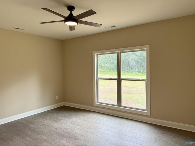 1112 Mountainview Rd NE, Hartselle, AL 35640 - unfurnished room with wood finished floors, baseboards, and ceiling fan