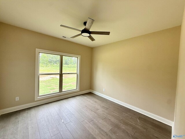 1112 Mountainview Rd NE, Hartselle, AL 35640 - unfurnished room with a ceiling fan, baseboards, and dark wood-style floors