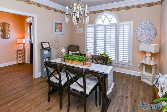 dining space with an inviting chandelier, crown molding, baseboards, and wood finished floors