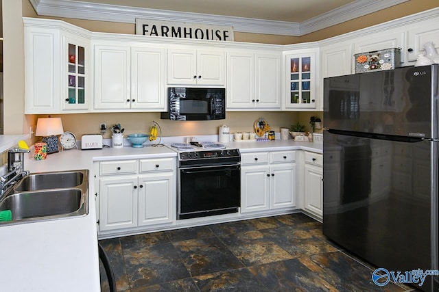 kitchen featuring light countertops, white cabinets, a sink, and black appliances