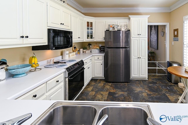 kitchen featuring electric range, white cabinets, freestanding refrigerator, light countertops, and black microwave