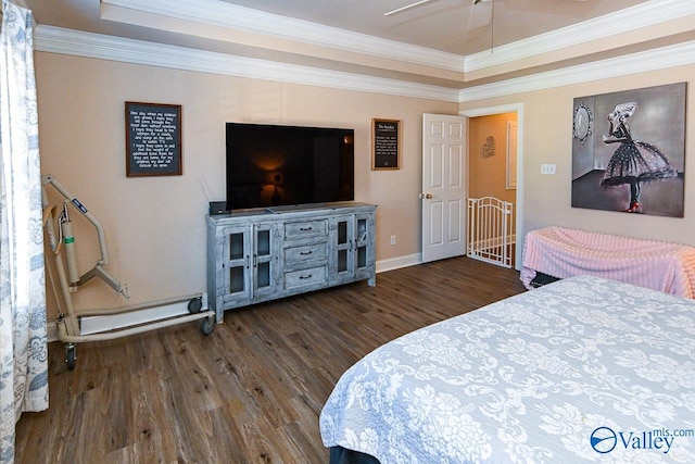 bedroom with baseboards, wood finished floors, and crown molding