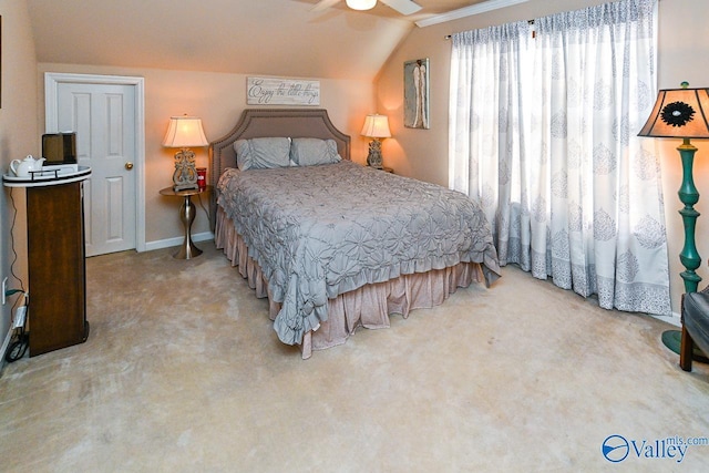 bedroom featuring lofted ceiling, baseboards, carpet floors, and a ceiling fan