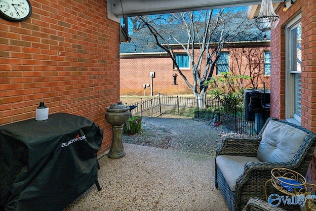 view of patio with fence and area for grilling