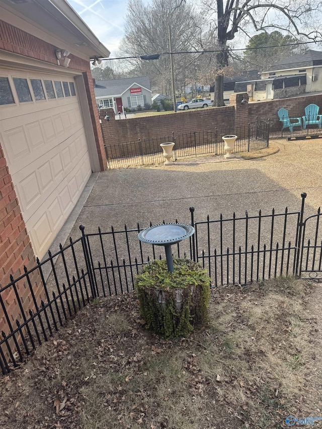 view of yard featuring a garage and fence