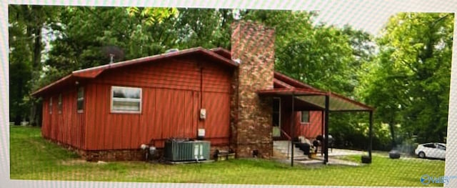 exterior space featuring a yard and cooling unit