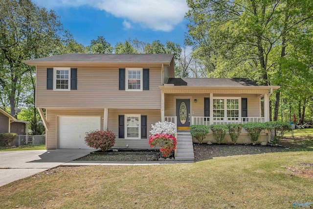 split level home with concrete driveway, an attached garage, a porch, and a front yard
