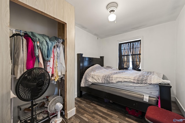 bedroom with dark hardwood / wood-style flooring