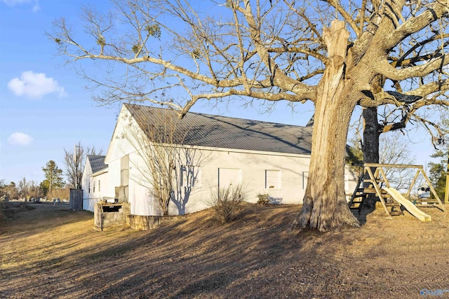 view of property exterior with a playground