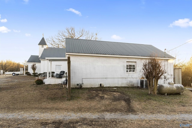 view of side of home with central AC