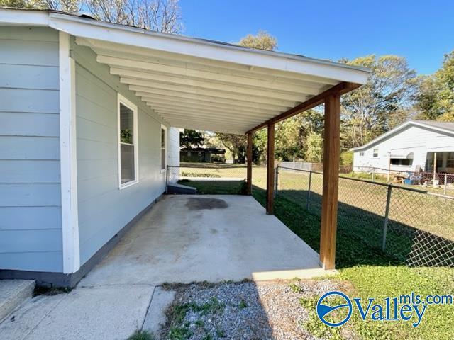 view of patio with fence and an attached carport