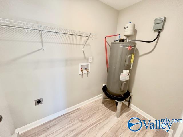 laundry room with electric dryer hookup, light wood-style floors, hookup for a washing machine, electric water heater, and laundry area