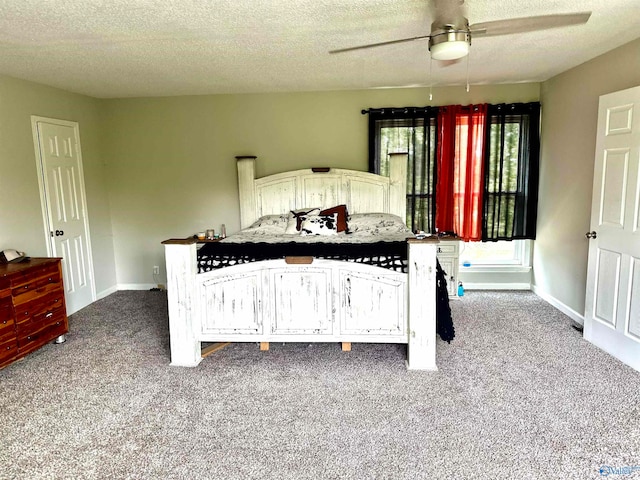 carpeted bedroom featuring a textured ceiling and ceiling fan