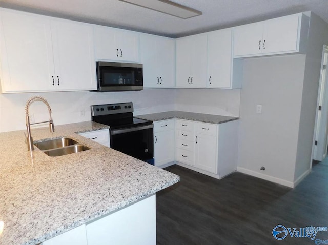 kitchen featuring light stone counters, sink, white cabinetry, stainless steel appliances, and dark hardwood / wood-style floors