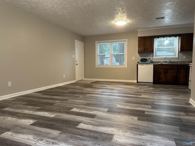 kitchen featuring dark wood-type flooring, dark brown cabinetry, white dishwasher, and sink