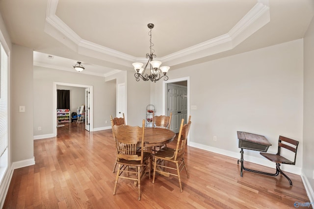 8 Cypress Point Dr, Huntsville, AL 35824 - dining room with a raised ceiling, crown molding, a chandelier, light wood finished floors, and baseboards