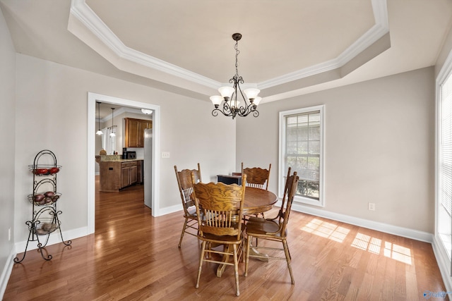 8 Cypress Point Dr, Huntsville, AL 35824 - dining space featuring a tray ceiling, a chandelier, crown molding, light wood-style floors, and baseboards
