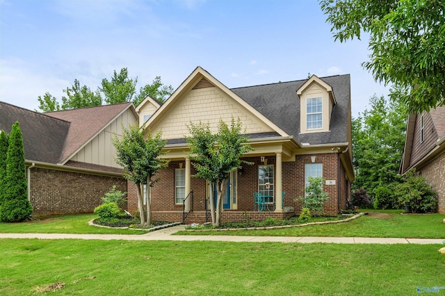 8 Cypress Point Dr, Huntsville, AL 35824 - craftsman-style home with brick siding, a front lawn, a porch, roof with shingles, and board and batten siding