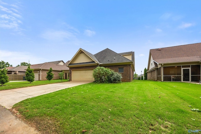 8 Cypress Point Dr, Huntsville, AL 35824 - view of front facade featuring a front yard, a garage, brick siding, driveway, and a sunroom
