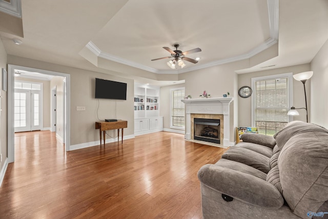 8 Cypress Point Dr, Huntsville, AL 35824 - living room with ceiling fan, light wood-type flooring, a tray ceiling, ornamental molding, and a fireplace