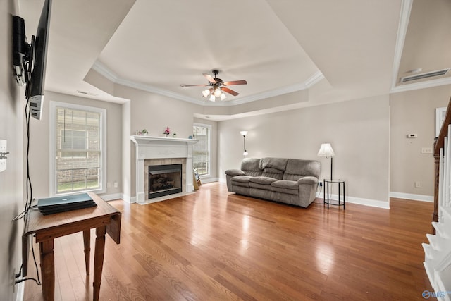 8 Cypress Point Dr, Huntsville, AL 35824 - living area featuring light wood-style floors, a tile fireplace, a ceiling fan, ornamental molding, and baseboards