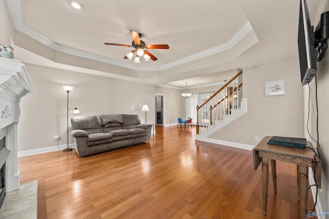 8 Cypress Point Dr, Huntsville, AL 35824 - living area with a premium fireplace, stairs, ceiling fan, a raised ceiling, and light wood-style flooring
