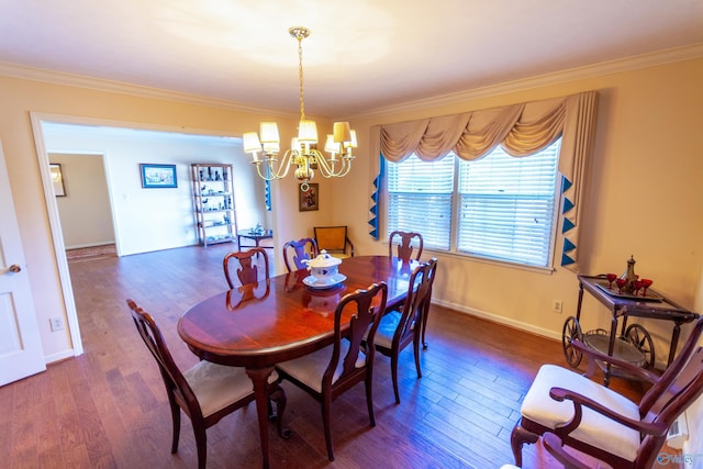 dining area with a notable chandelier, crown molding, baseboards, and wood finished floors