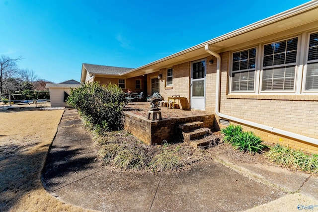 exterior space with a patio and brick siding