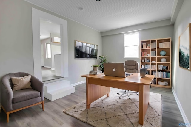 home office with hardwood / wood-style floors