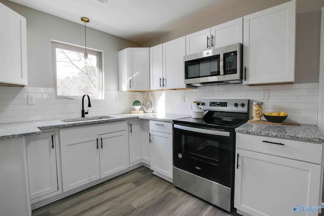 kitchen featuring white cabinets, decorative backsplash, sink, and stainless steel appliances