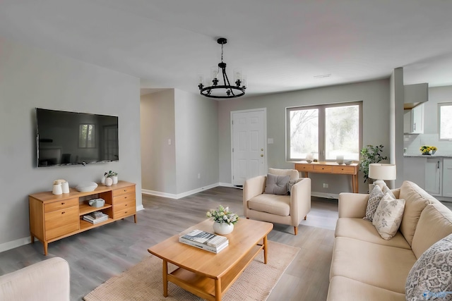 living room with wood-type flooring and a notable chandelier