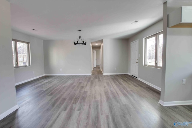 interior space featuring hardwood / wood-style floors, plenty of natural light, and a notable chandelier