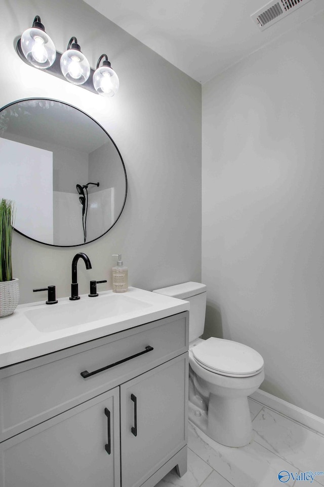 bathroom featuring vanity and toilet