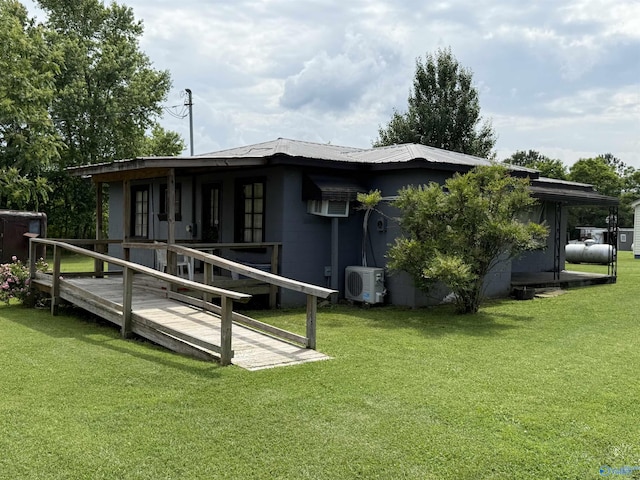 4094 County Road 66, Section, AL 35771 - back of property with a cooling unit, concrete block siding, a yard, and metal roof