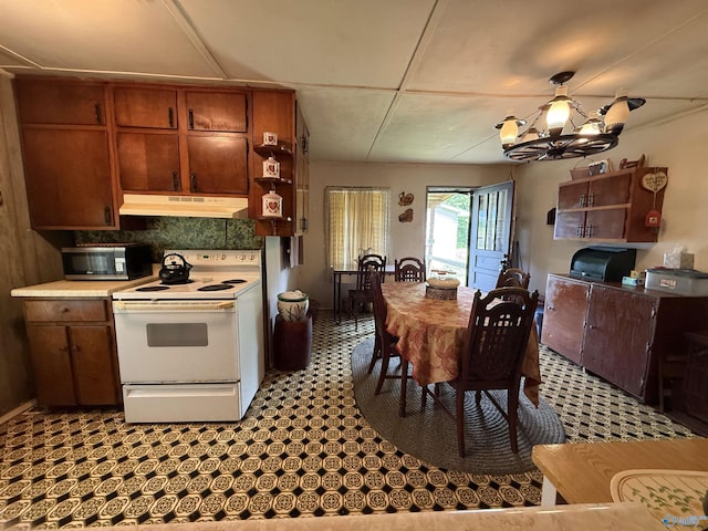 4094 County Road 66, Section, AL 35771 - kitchen featuring white electric stove, under cabinet range hood, stainless steel microwave, a chandelier, and tasteful backsplash